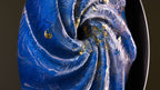 Close-up of blue spiral light artwork with textured fire-shaped surface and gold leaf details, abstract circular fine art print Cherulight by Burningpictures